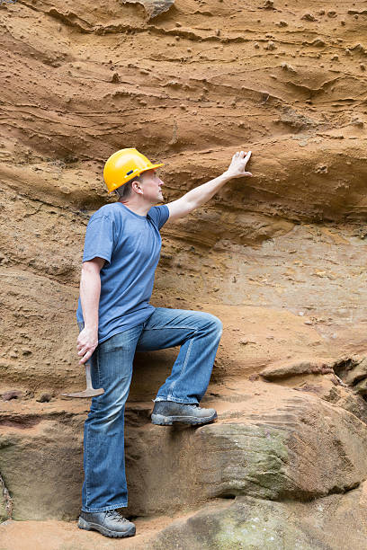 istock male geologist examining sandstone 187025978