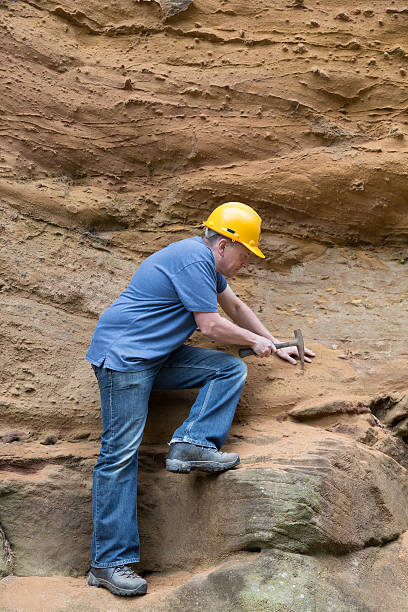 male geologist examining sandstone