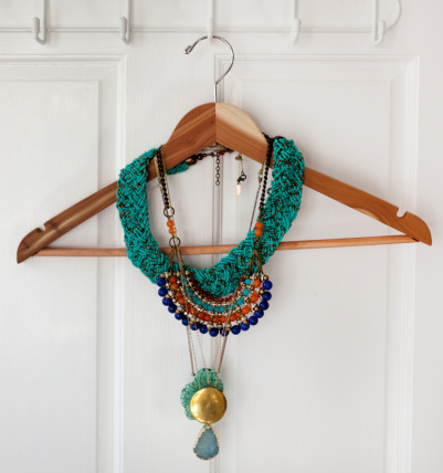 Necklaces on a wood hanger.