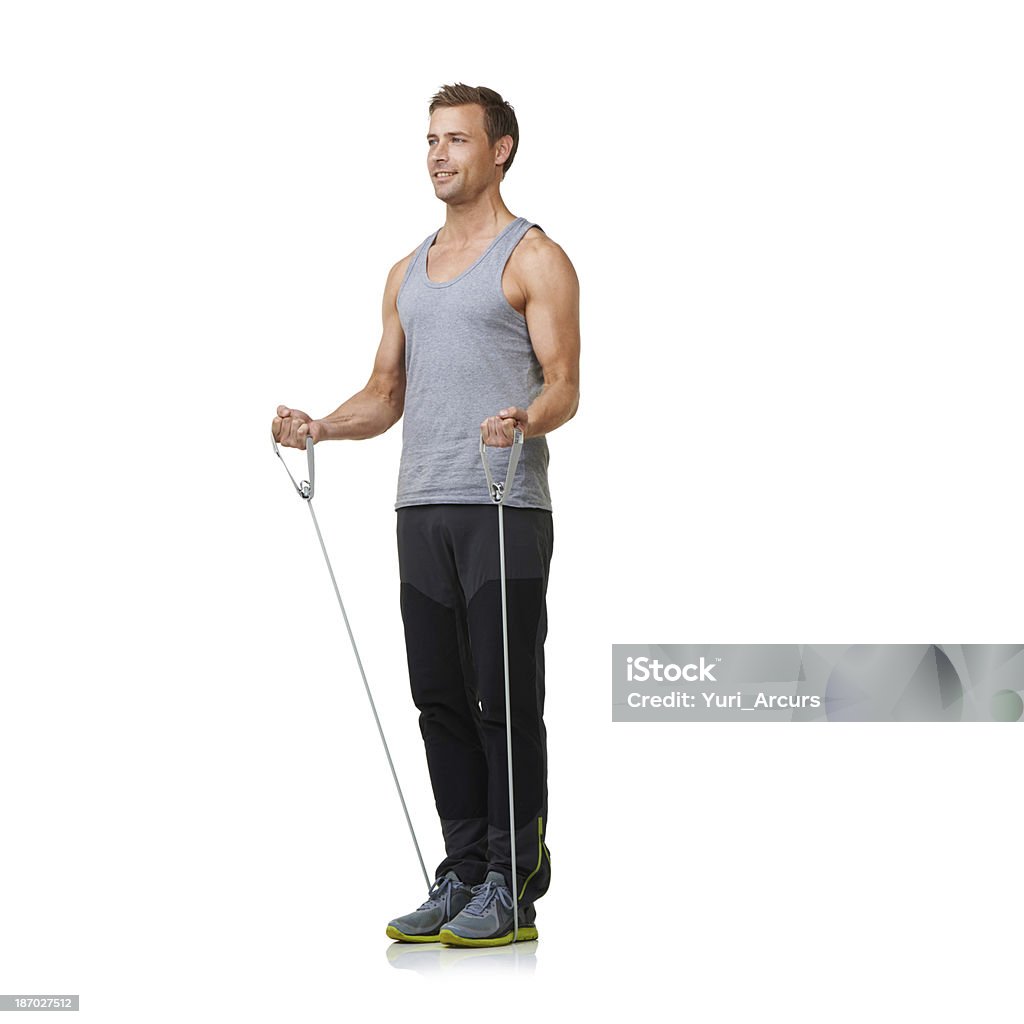 Dedicated to strength and fitness A fit young man working out with a resistance band while isolated on a white background 20-24 Years Stock Photo