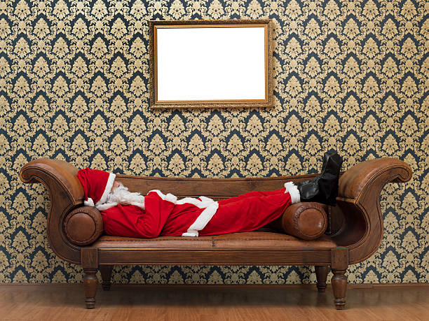 istock Tired Santa Claus lying on sofa 187028613