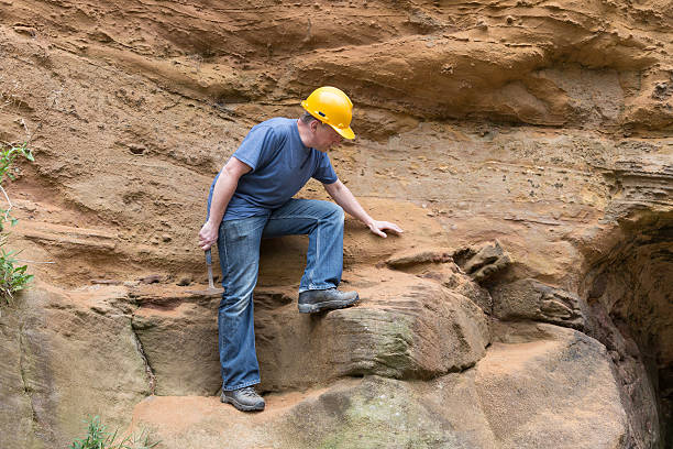 istock male geologist examining sandstone 187029819