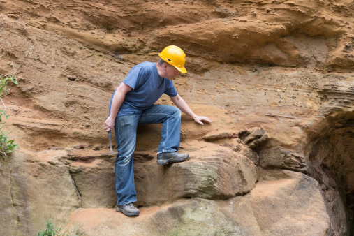 male geologist examining sandstone