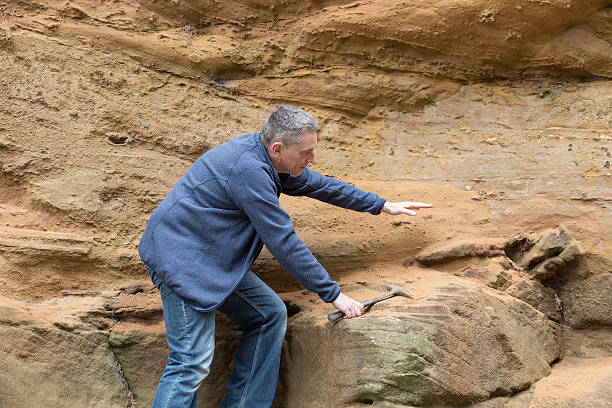 istock male geologist examining sandstone 187029826
