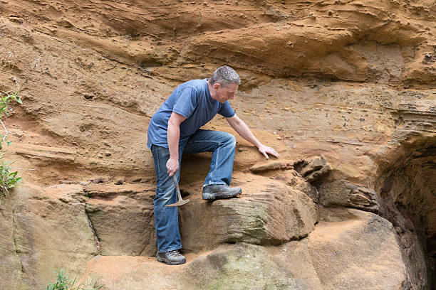 istock male geologist examining sandstone 187029903