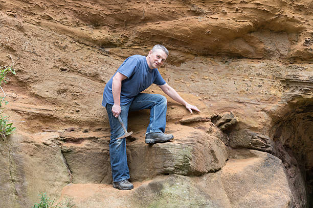 istock male geologist examining sandstone 187029936
