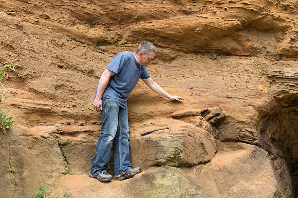 istock male geologist examining sandstone 187029939