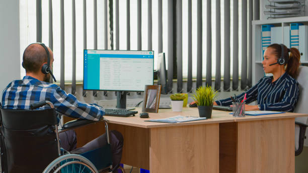 istock Paralysed businessman headset making teleappointment 1870319317