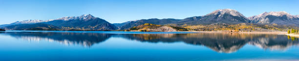 Panorama of Lake Dillon in the Colorado Rocky Mountains Panoramic image of Lake Dillon in Summit County, Colorado.  Ten Mile Range, Buffalo, and Red Mountains are visible.  Lake Dillon is a reservoir that supplies Denver with water.  Ten Mile Range is the location of Breckenridge Ski Resort.  Fall Colors are visible along the shore and partly up the mountains. tenmile range stock pictures, royalty-free photos & images