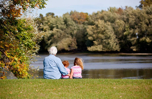 istock Girls & Grandma Sitting by River 187032401