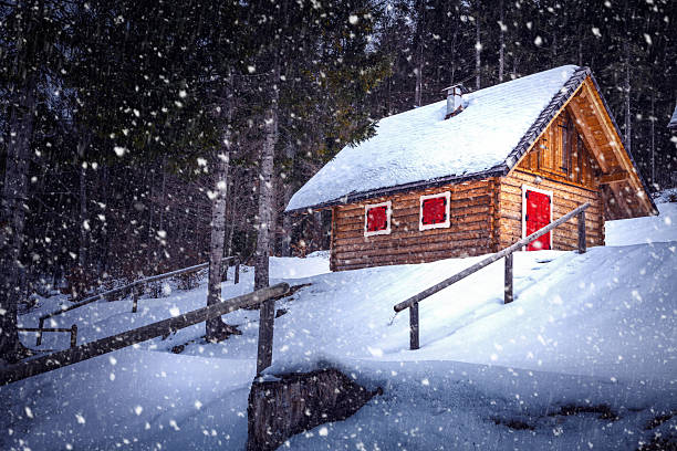 Wodden hut by ski slope on a snowy winter day.