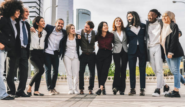 istock large group of multicultural and multigenerational workers in suits posing for a photo, celebrating company achievements 1870330481