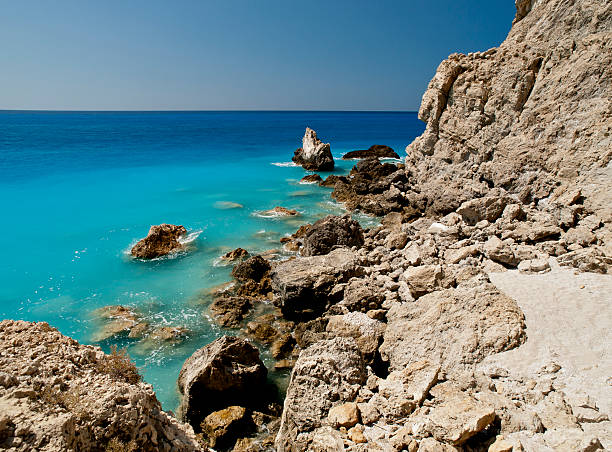 Rocks and water The rocky left edge of Egremni beach found in Lefkada, Greece. egremni beach lefkada island greece stock pictures, royalty-free photos & images