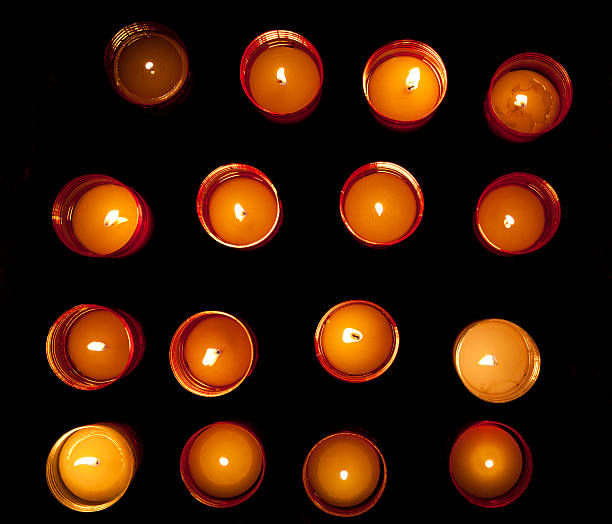 Top view of twelve red golden burning candle lights