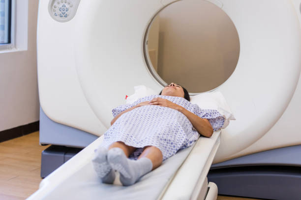istock Patient prepares to go through CAT scan machine 1870342628