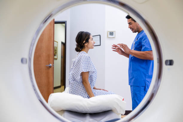 istock Male radiographer talks with attentive female patient 1870343103