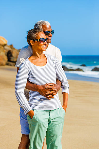 istock Senior African American couple embracing on beach 187034350