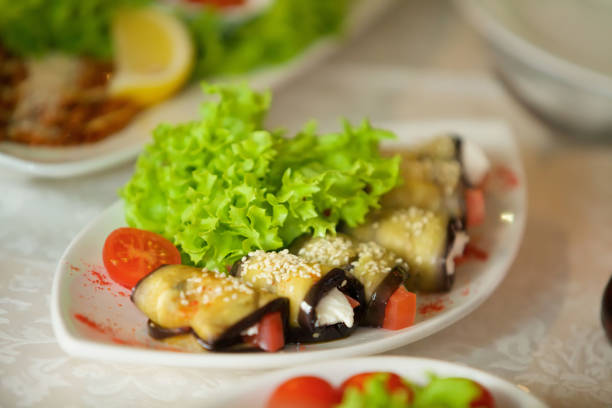 istock A dish of toppings, wrapped in fried eggplant. 1870347985