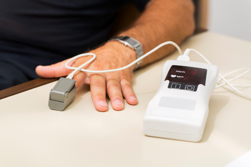 A hendheld pulse oximeter...patient at the doctor having tests