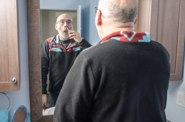 istock Mature man cutting nose's hair 1870350587