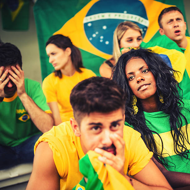istock Group of brazilian supporters sad at stadium 187035091