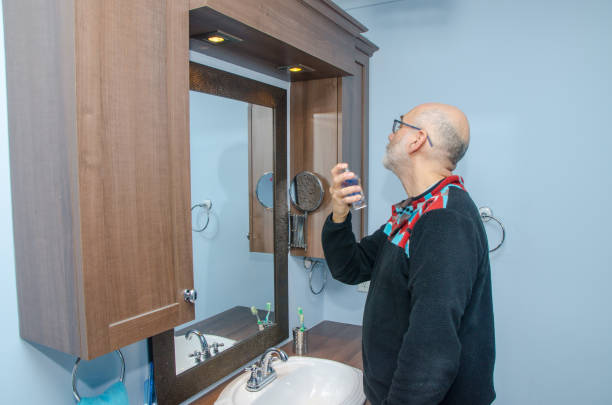 istock Mature man putting cologne 1870353180