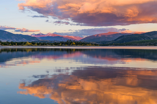 A colorful sunset view of Dillon Reservoir on a calm Autumn evening. Dillon, Summit County, Colorado, USA.
