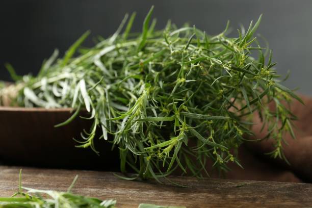 istock Bunch of fresh tarragon on wooden table 1870356797