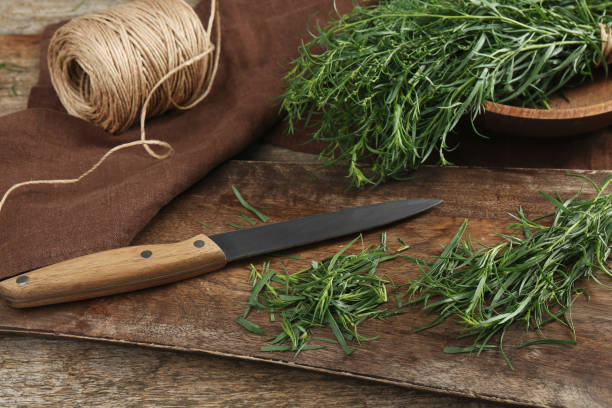 istock Fresh whole and cut tarragon sprigs on wooden table 1870357847