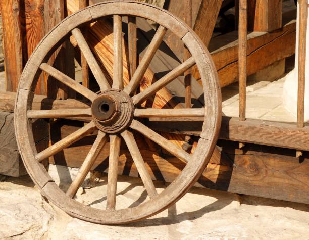 istock Old wooden hand-wrought cart wheel. 1870361055