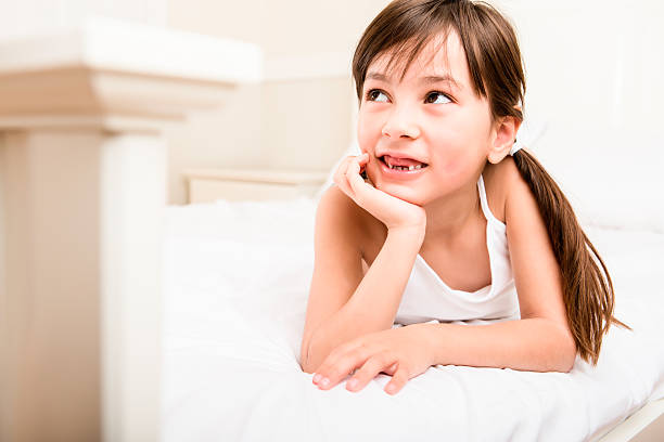 Young 8 year old girl laying in bed