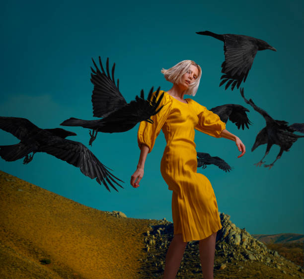 istock blonde woman in action with flying ravens 1870369563