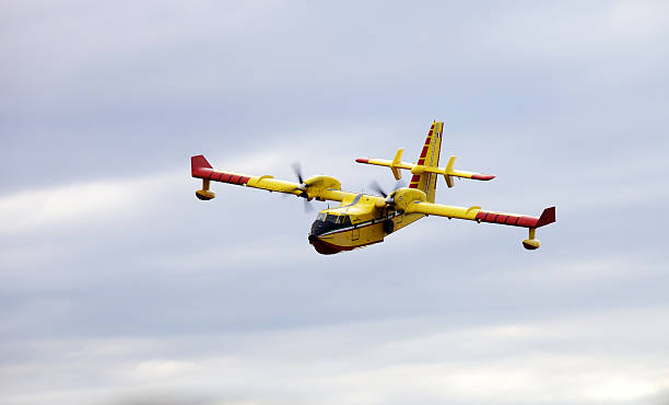 istock A yellow firefighter airplane flying in a cloudy sky. 187037482