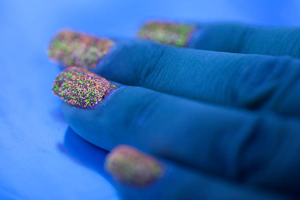 Hand with multicolor nails polish on white background