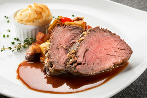 Herb crusted beef tenderloin served with saute vegetables of onions, mushrooms, squash, and red bell peppers, a souffle of mashed potatoes, and a light gravy.