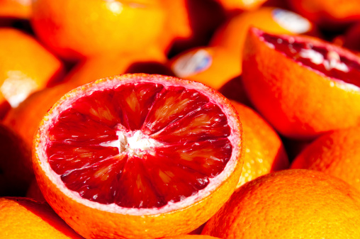 Sunlit blood oranges at a vendors stall.