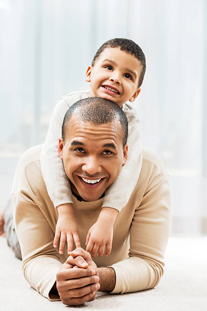 istock Father playing with son at home. 187038194
