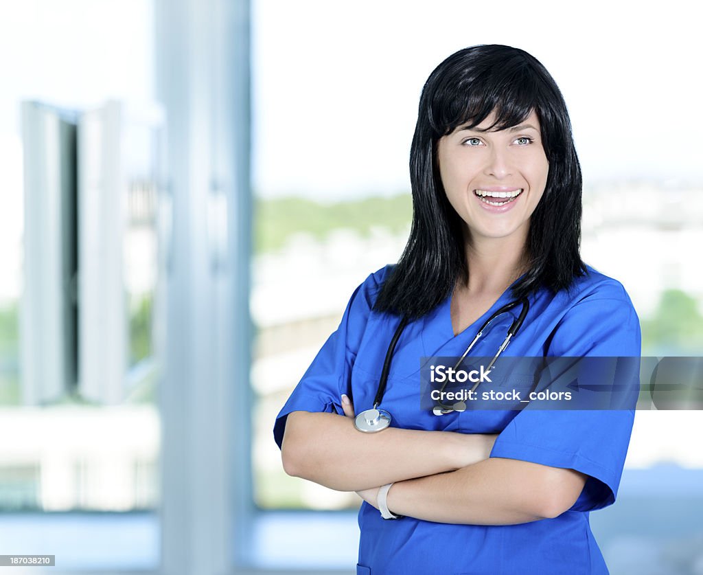 cheerful doctor young doctor portrait holding arms crossed and smiling. 25-29 Years Stock Photo