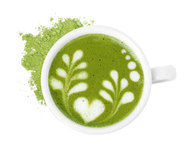 istock Delicious matcha latte in cup and powder on white background, top view 1870382116