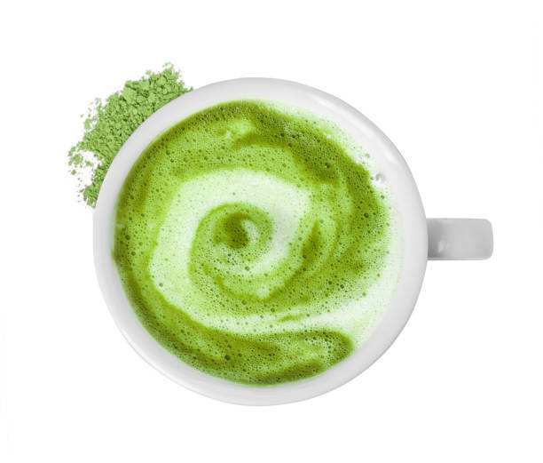 istock Delicious matcha latte in cup and powder on white background, top view 1870382637