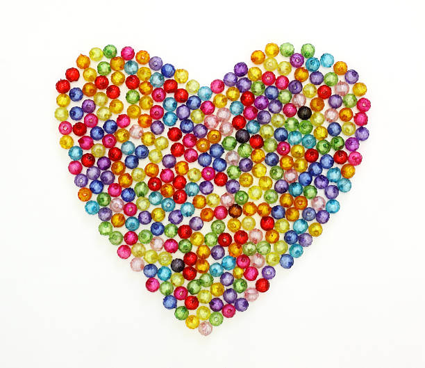 istock Colorful beads heart shape isolated on white background 187039050