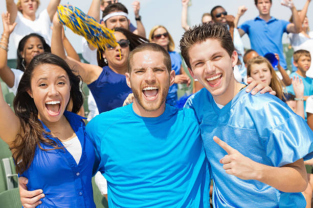 istock Sports fans cheering on team in crowded stadium 187039711