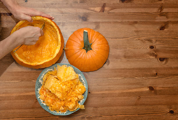 Hollow out a pumpkin on Halloween stock photo