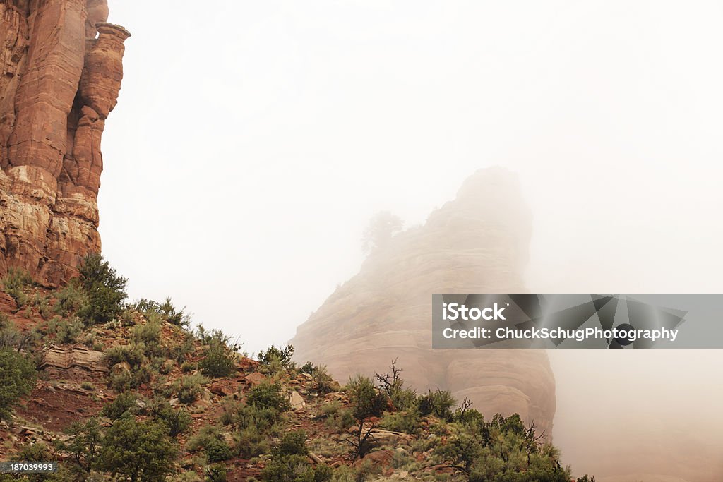 Desert Butte Wilderness Fog Landscape Fog veils red rock buttes in succession in a high desert wilderness landscape.  Yavapai County, Arizona, 2013. Arizona Stock Photo