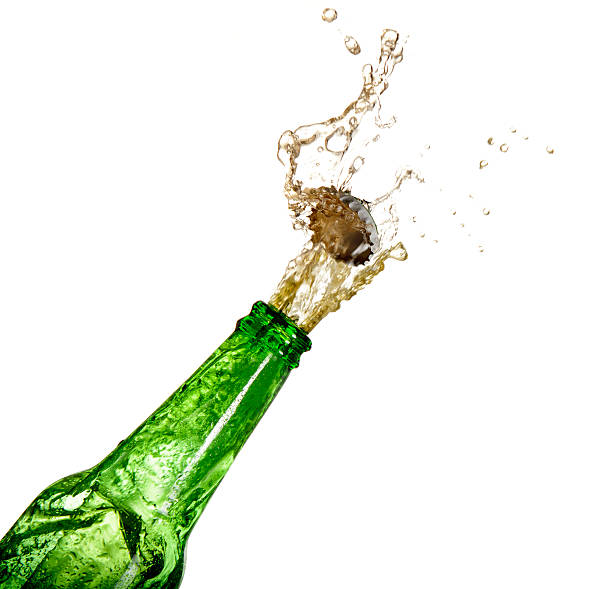 Splashing Beer Beer exploding under pressure on white background. Please see my portfolio for other food and drink images. opening bottle cap photos stock pictures, royalty-free photos & images