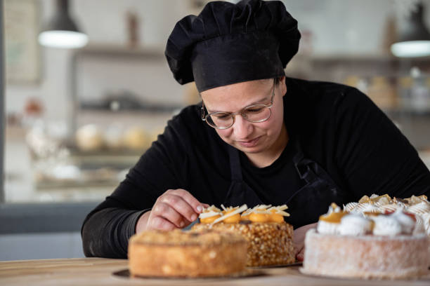 istock Concentrated female chef arranging cakes to sell 1870401485
