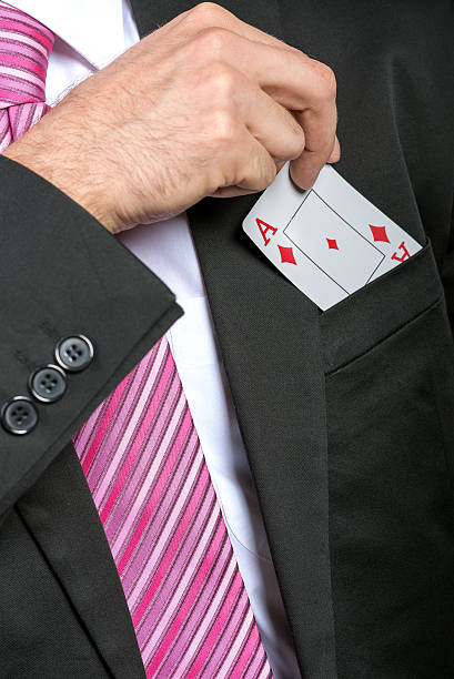 istock businessman pulling out his pocket aces cards 187040206