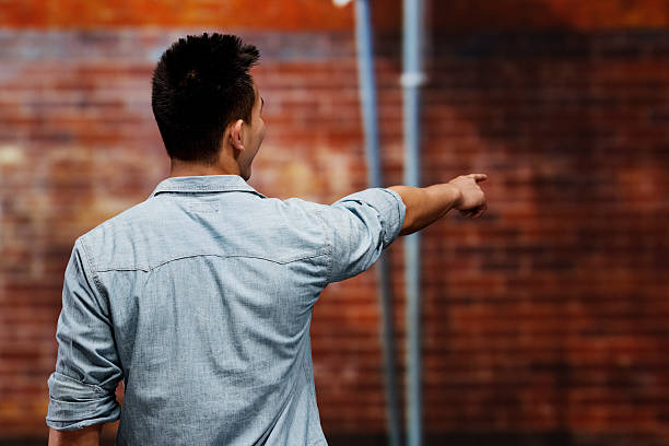 istock Rear view of young man gesturing 187040573