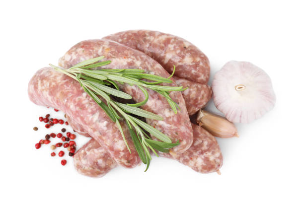 istock Raw homemade sausages and different spices isolated on white, top view 1870409751