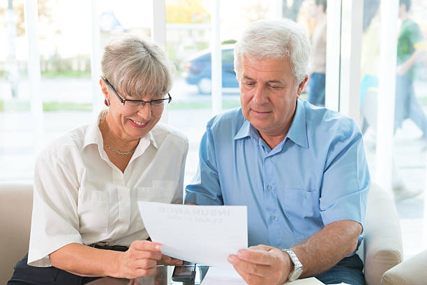 istock Senior couple read the form for life insurance 187040977